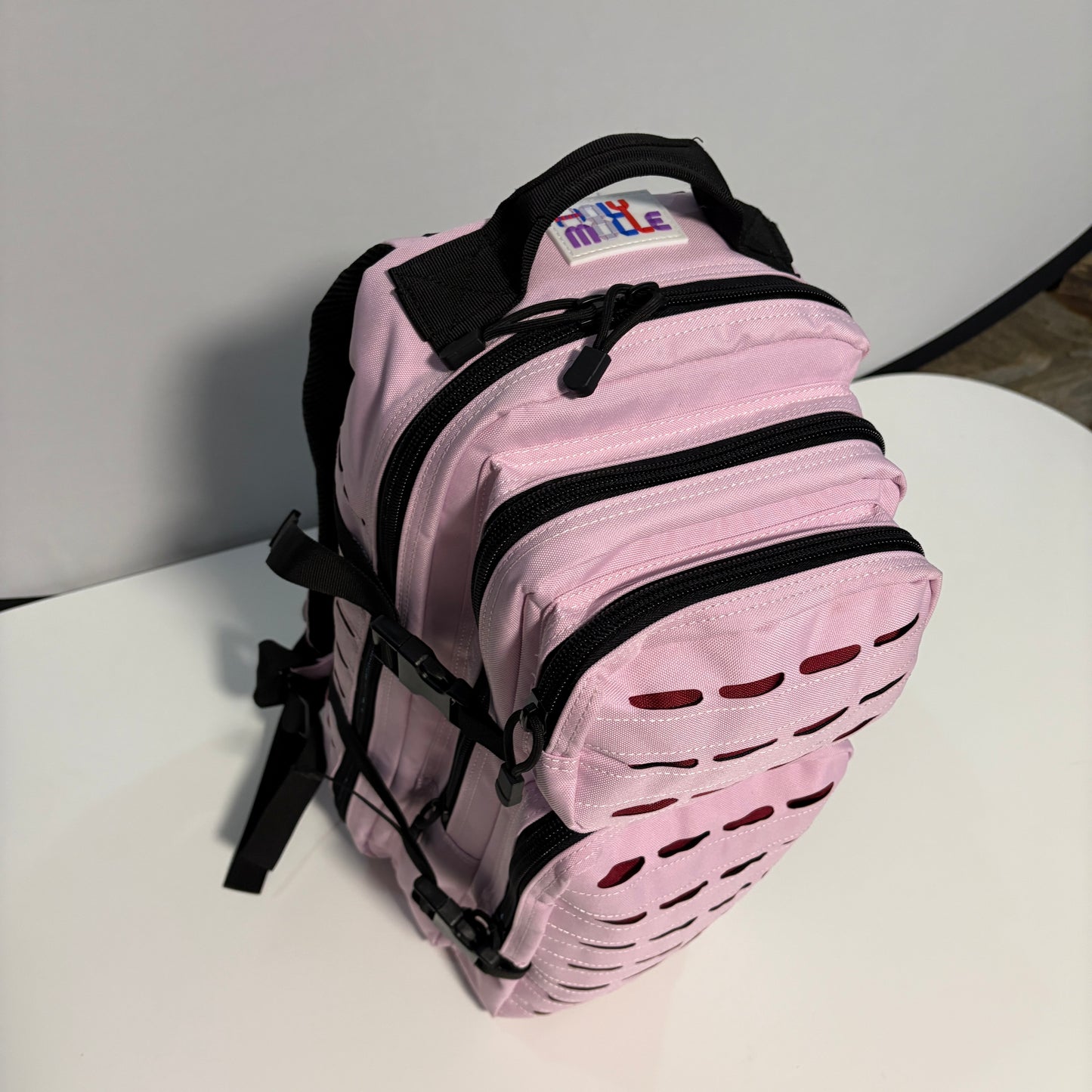 The COTTON CANDY Slimline Backpack with Laser Cut Molle in Pink - 25L