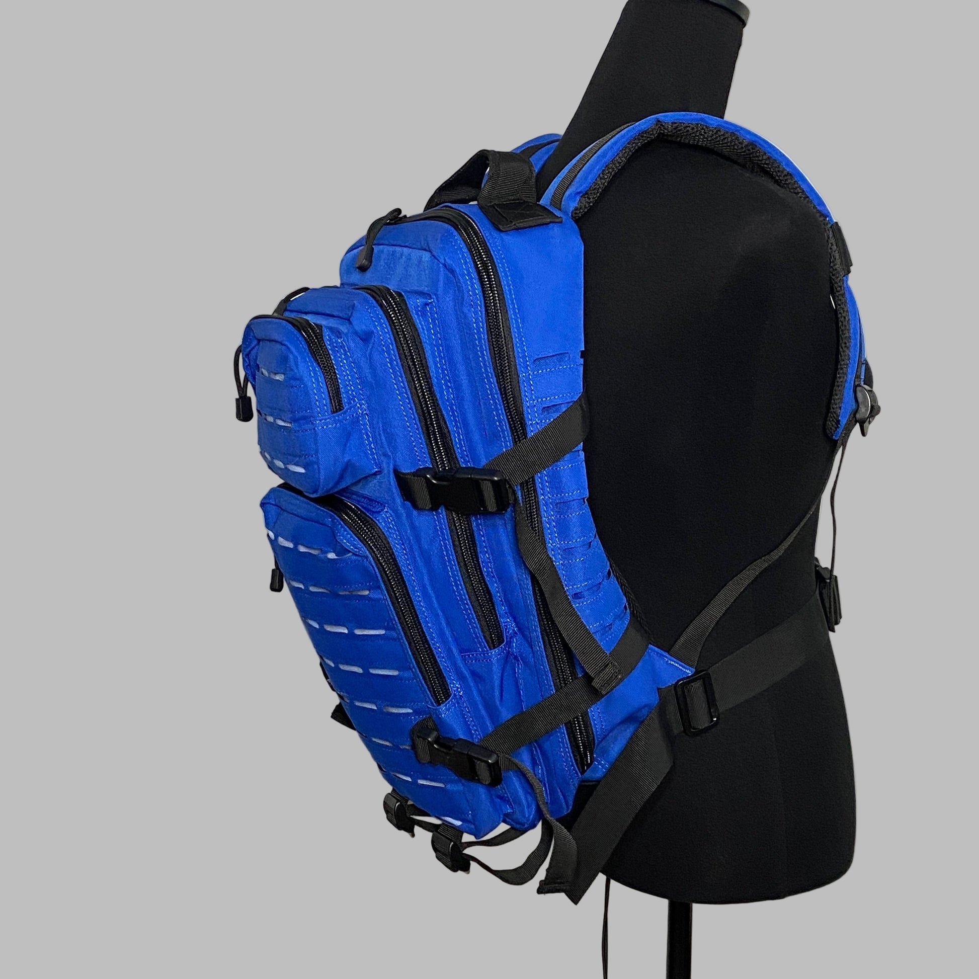 Blue tactical backpack on a mannequin against a plain background